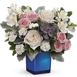Pink and white roses with white alstroemeria in a blue vase