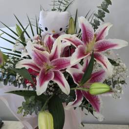 Bouquet of pink-and-white lilies with a small Hello Kitty plush