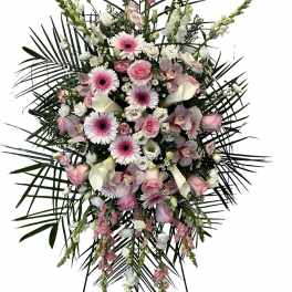 Pink and white floral standing spray with palm fronds