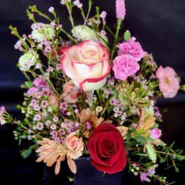 Mixed bouquet with red and pink roses and small filler flowers