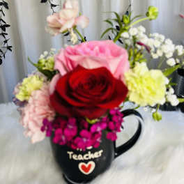 Mixed flower bouquet in a black teacher mug