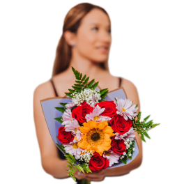 Woman holding a bouquet of red roses, a sunflower, and pale pink daisies