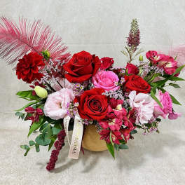 Mixed bouquet of red and pink roses in a gold vase