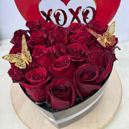 Heart-shaped box of red roses with butterfly decorations