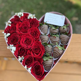 Heart-shaped box with red roses and chocolate-covered strawberries