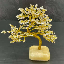 Decorative crystal tree sculpture on a stone base