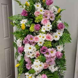 Tall standing floral spray with pink roses, white daisies, and yellow tulips