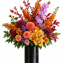 Colorful mixed flower arrangement in a black vase