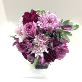 Purple and pink bouquet in a black vase