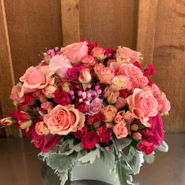 Pink and red rose bouquet in a white vase