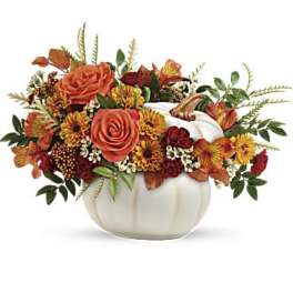 Autumn floral arrangement in a white pumpkin-shaped vase