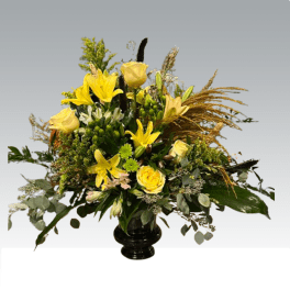 Yellow lilies and roses in a black vase