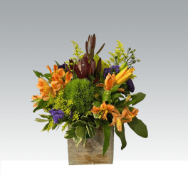 Orange and purple mixed bouquet in a square wooden container
