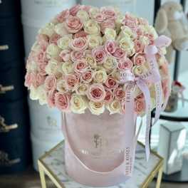 Large bouquet of pink and cream roses in a pink hatbox with ribbon