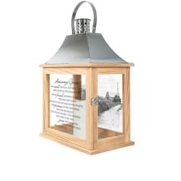 Wooden lantern with a metal top and printed glass panels