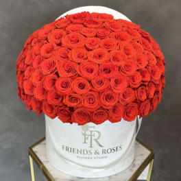 Large red rose arrangement in a white round hat box