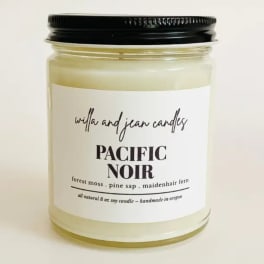 Jar candle with a black lid and white label reading Pacific Noir