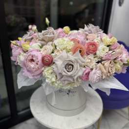 Pastel bouquet of roses, peonies, and ranunculus in a white hat box