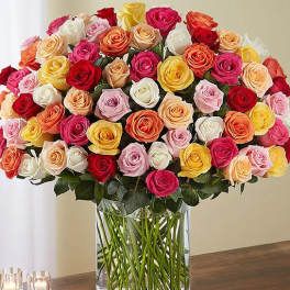 Large bouquet of multicolored roses in a clear glass vase