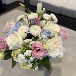 Bouquet of white, pink, and blue flowers in a vase