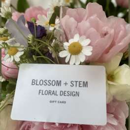 Pink and white flowers with a gift card in the center