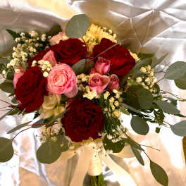 Bouquet of red and pink roses with baby's breath and eucalyptus