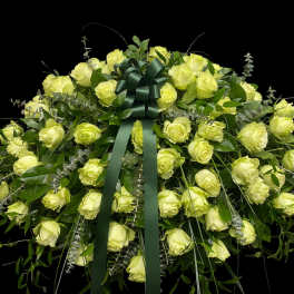 Large bouquet of pale yellow roses with a dark green ribbon