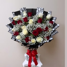 Bouquet of red and white roses with baby's breath in black-and-white wrap