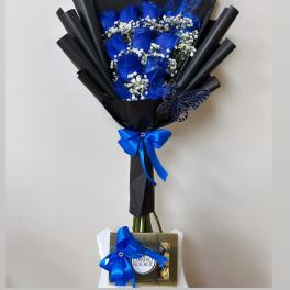 Blue rose bouquet with baby’s breath, black wrap, and a Ferrero Rocher box