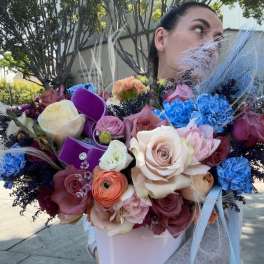 Large bouquet of mixed roses and carnations in a white box