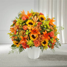 Orange and yellow mixed bouquet in a white vase