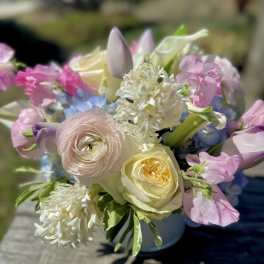 Pastel bouquet with roses, ranunculus, and mixed blooms in a vase