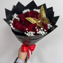 Bouquet of red roses with white baby's breath and a gold butterfly accent