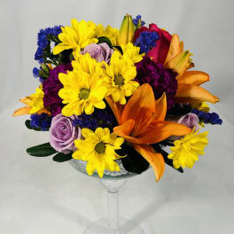 Colorful bouquet in a clear stemmed glass vase
