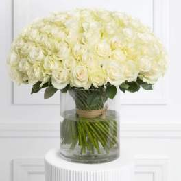 Large bouquet of white roses in a clear glass vase