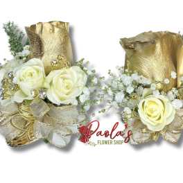 Two gold-wrapped rose arrangements with white roses and baby's breath