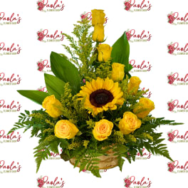 Yellow roses and a sunflower in a basket arrangement