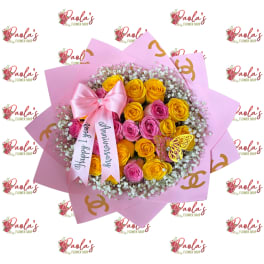 Pink and yellow rose bouquet with a satin bow and anniversary ribbon