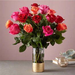 Bouquet of multicolored roses in a clear glass vase