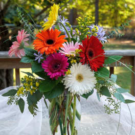 Colorful gerbera daisy bouquet in a clear glass vase