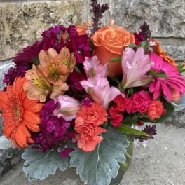 Bright mixed bouquet with orange roses, gerbera daisies, and pink flowers