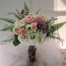 Bouquet of pink and white flowers with fern-like greenery
