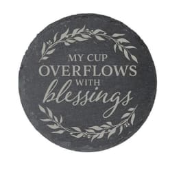 Round black stone plaque with the words "My cup overflows with blessings"