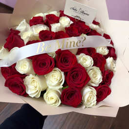 Bouquet of red and white roses with a "Be Mine?" ribbon