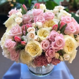 Bouquet of pink and cream roses in a glass vase
