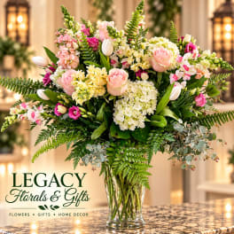 Large mixed bouquet of pink and white flowers in a clear glass vase
