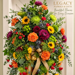 Large standing floral spray with sunflowers, roses, and chrysanthemums