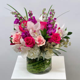 Pink and white mixed bouquet in a clear glass vase