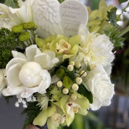 White and pale green floral bouquet with a memorial heart plaque