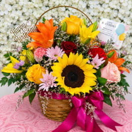 Colorful mixed flower basket with a birthday sign and card